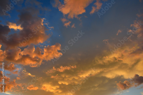 Colorful altocumulus clouds on blue sky background with sunrise. photo