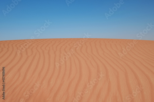 Sunset over the sand dunes in the desert.