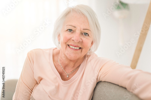 portrait of elderly woman sit on the sofa at home