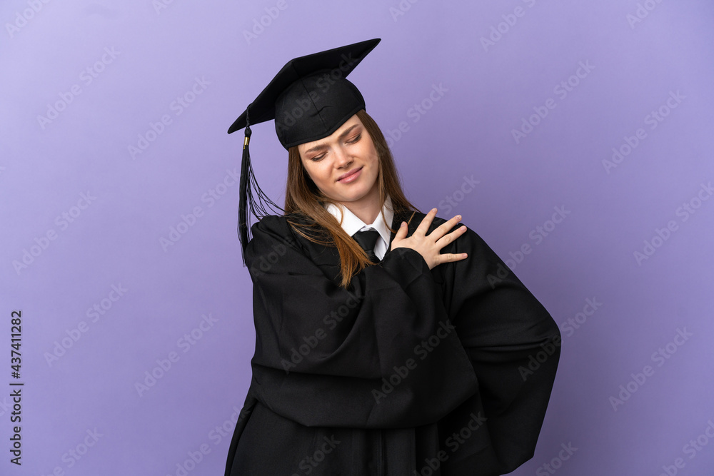 Young university graduate over isolated purple background suffering from pain in shoulder for having made an effort Young university graduate over isolated purple background suffering from pain in shoulder for having made an effort