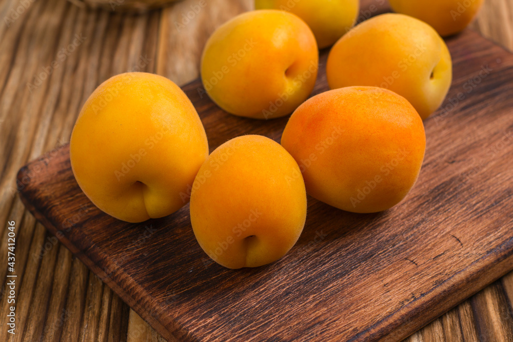 Composition with fresh ripe apricots on wooden background Composition with fresh ripe apricots on wooden background