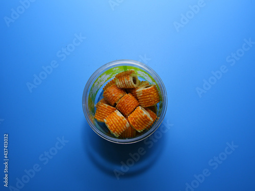 "Tart Nenas" on isolated blue background. Traditional Malaysian cookies snack.