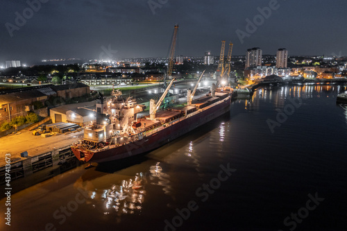 A Ship Docked at Port at Night Awaiting Cargo for Shipping