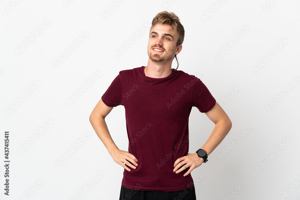Young handsome man isolated on white background posing with arms at hip and smiling Young handsome man isolated on white background posing with arms at hip and smiling