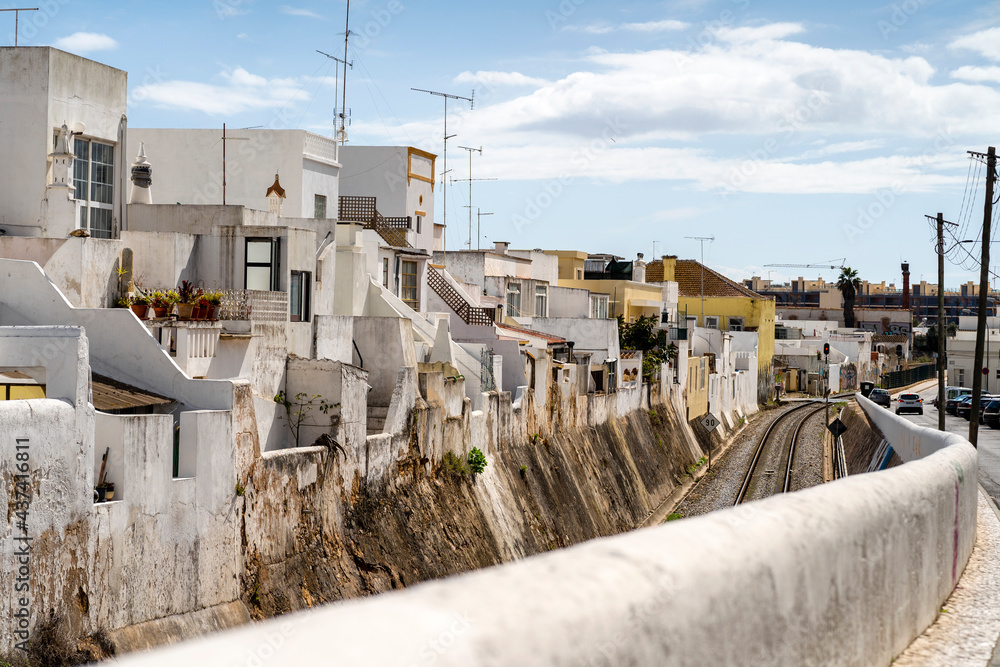 Cubist white-washed houses by railway in Olhao, Portugal