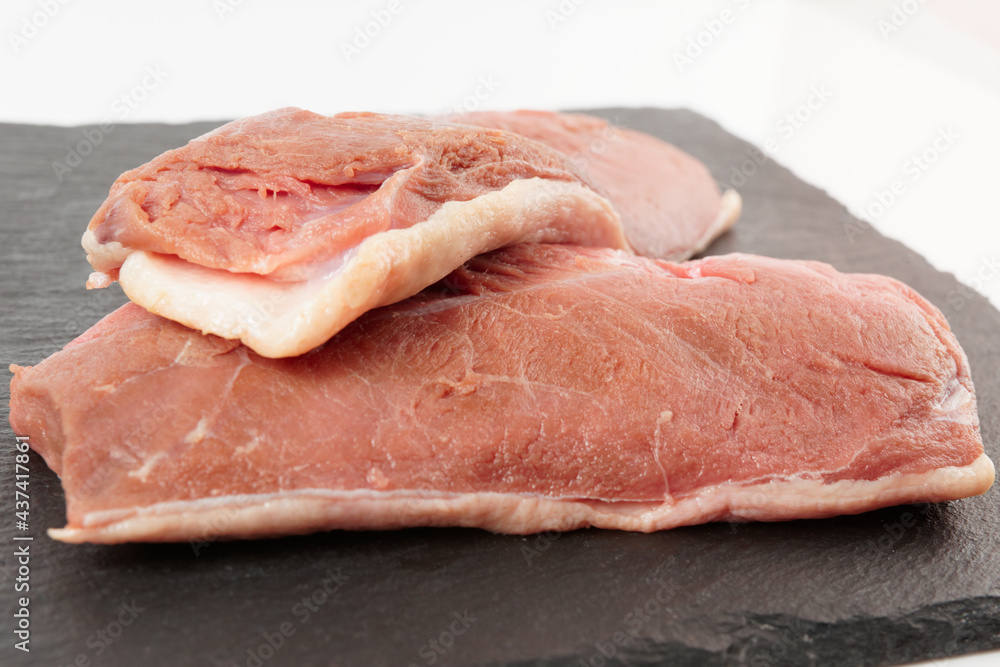 Two lean duck fillets shot on black slate plate Two lean duck fillets shot on black slate plate