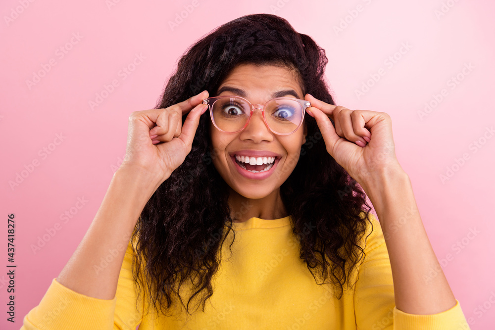 Photo of young excited african girl happy positive smile hands touch glasses isolated over pastel color background Photo of young excited african girl happy positive smile hands touch glasses isolated over pastel color background