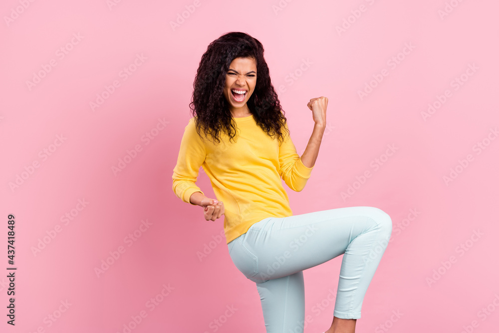 Profile side photo of young african girl happy positive smile rejoice win lottery fists hands isolated over pastel color background Profile side photo of young african girl happy positive smile rejoice win lottery fists hands isolated over pastel color background
