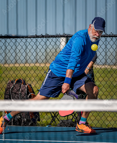 Adult male pickleball with eyes on the ball