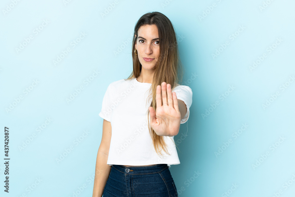 Young caucasian woman over isolated background making stop gesture Young caucasian woman over isolated background making stop gesture
