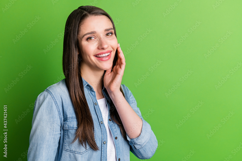 Portrait of attractive cheerful girl copy space touching face isolated over bright green color background Portrait of attractive cheerful girl copy space touching face isolated over bright green color background