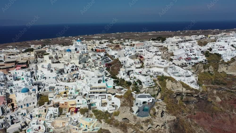 Famous white houses and blue domes on the edge of the cliff. Oia, Santorini. Greece. Aerial view. Famous white houses and blue domes on the edge of the cliff. Oia, Santorini. Greece. Aerial view.