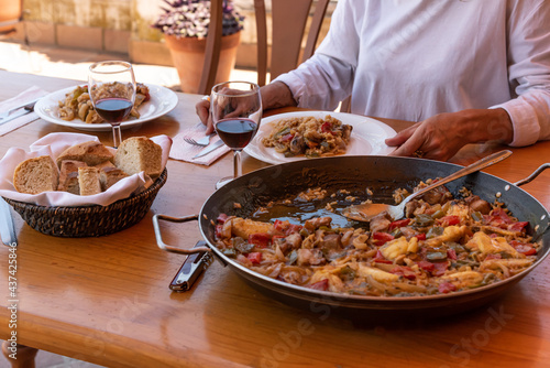 Preparation of typical Spanish food paella with chicken meat pork rice and vegetables