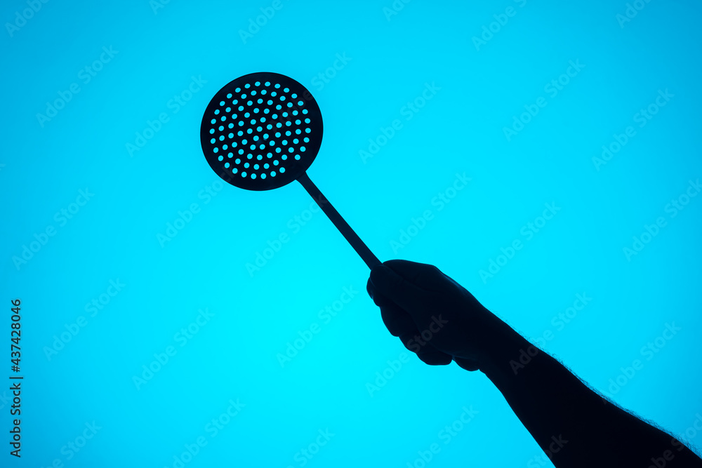 Hand diagonally with a skimmer. Cooking elements Hand diagonally with a skimmer. Cooking elements