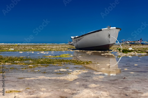 Beautiful view of the boat in the bay of the Mediterranean Sea at low tide on the island of Djerba, Tunisia