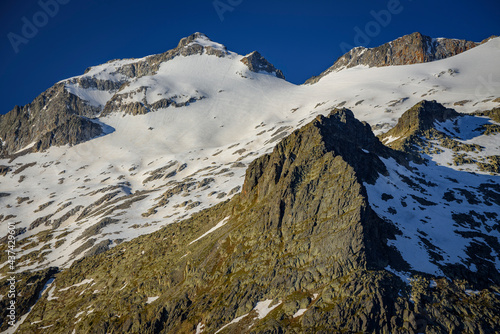 Maladeta Massif and the Aneto summit, the hightest peak in the Pyrenees, in a summer sunrise, seen from the path to the port of Benasque. (Benasque Valley, Aragon, Pyrenees, Spain) photo