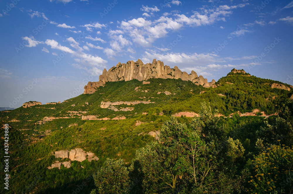 Montserrat west face with some rock formations like Roca Foradada and Serrat de la Portella in a summer afternoon (Barcelona province, Catalonia, Spain)