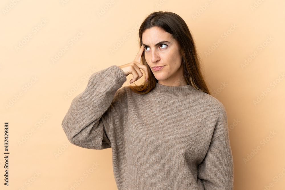 Young caucasian woman over isolated background making the gesture of madness putting finger on the head Young caucasian woman over isolated background making the gesture of madness putting finger on the head
