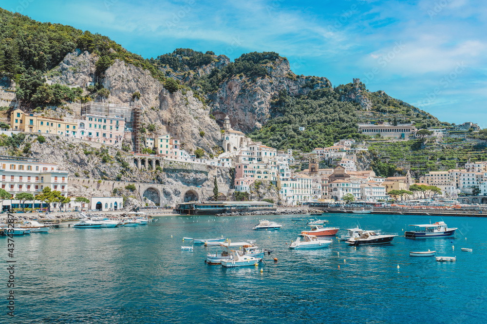 Amalfi coast is most popular travel and holiday destination in Europe.  Village with tiny beach and colorful houses located on rock. Italian summer paradise. Mountains on Amalfitana coastline. 