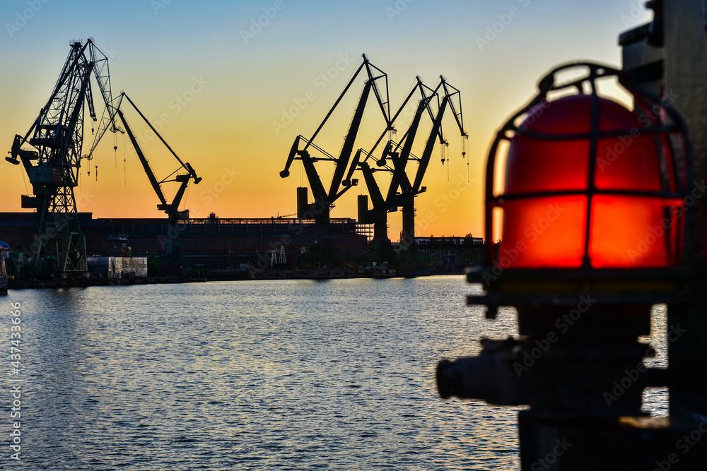 Beautiful sunset and cranes in a shipyard in Gdansk, Poland