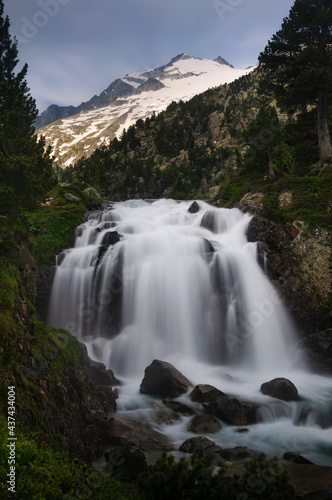 Plan and Forau d Aigualluts  meadow and a waterfall  under the Aneto summit in summer  Benasque  Pyrenees  Spain 