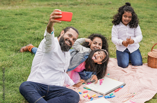 Photography Happy indian family enjoy day outdoor at city park with pic nic and toys while t