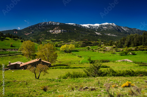 Serra d'Ensija snowy mountain range seen from Gisclareny village in a spring morning (Barcelona province, Catalonia, Spain, Pyrenees) photo