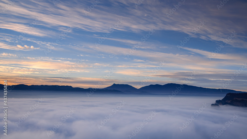Sunrise with a sea of clouds over the village of Vilanova de Sau. Views from the Roca del Migdia summit (Osona, Catalonia, Spain) Sunrise with a sea of clouds over the village of Vilanova de Sau. Views from the Roca del Migdia summit (Osona, Catalonia, Spain)