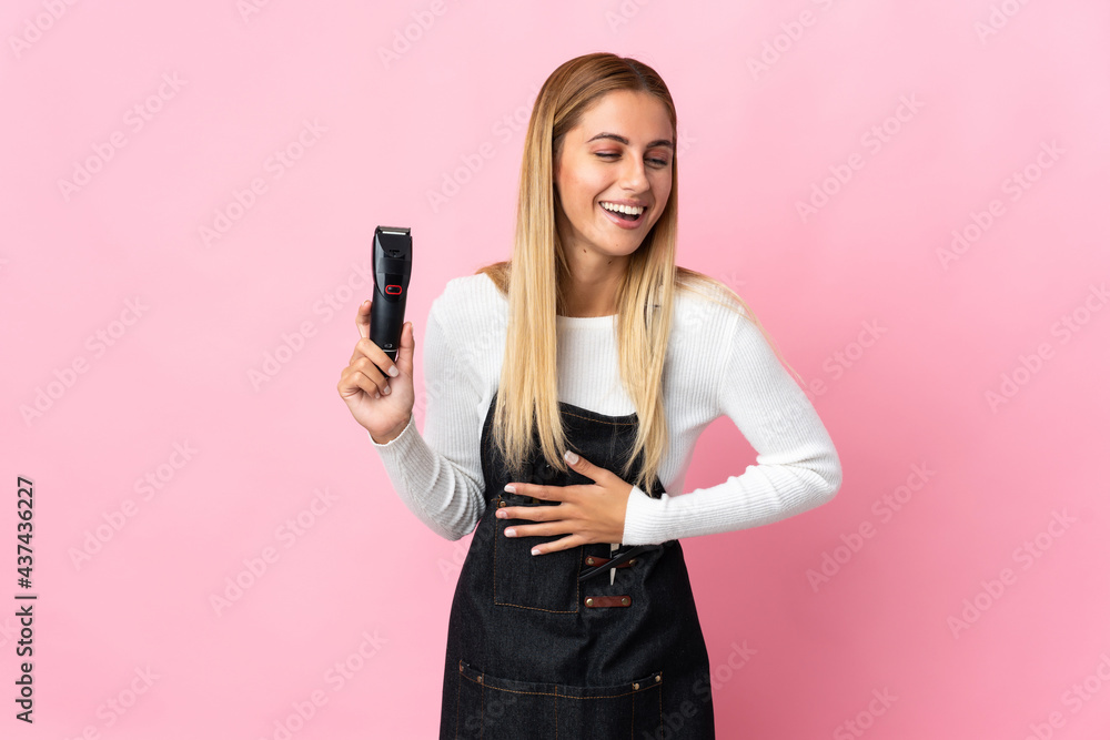 Young hairdresser woman isolated on pink background smiling a lot Young hairdresser woman isolated on pink background smiling a lot
