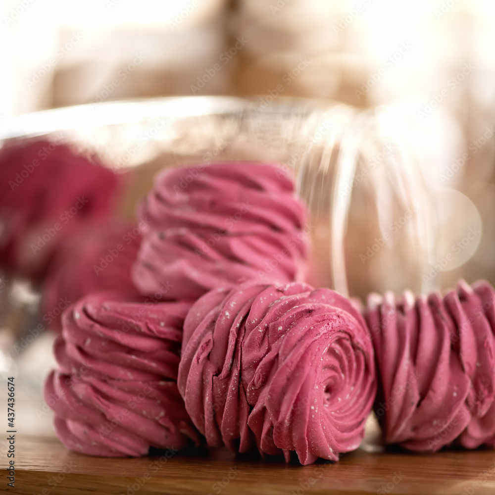 Pink Marshmallow, close up. Rose shaped dessert on blurred sunny background. Homemade Sweets for loved one or holiday event. Soft focus. Pink Marshmallow, close up. Rose shaped dessert on blurred sunny background. Homemade Sweets for loved one or holiday event. Soft focus.