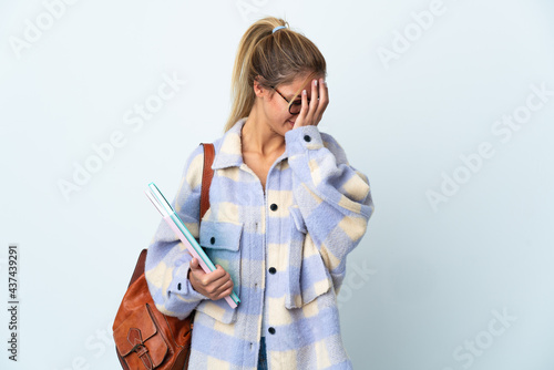 Young student woman isolated on white background with tired and sick expression © luismolinero