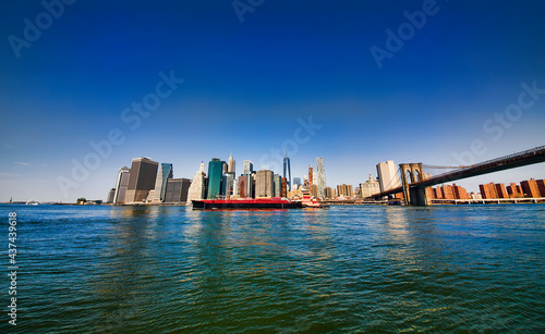 Industrial Ship Passing Downtown Manhattan on East River, New York