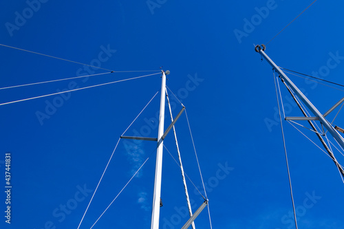Moon, cloud, sailing boat mast in blue sky background