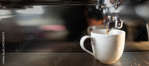 Coffee machine and a cup of coffee in a cafe. Promotional poster and making espresso. Professional coffee equipment.