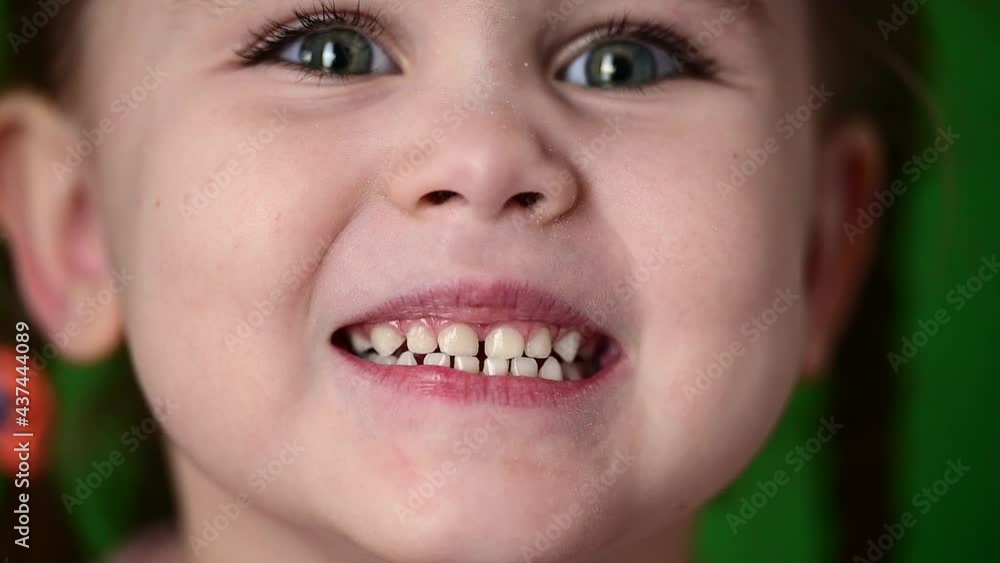 Time-lapse of a beautiful girl, little girl on a green background close up. Time-lapse of a beautiful girl, little girl on a green background close up.