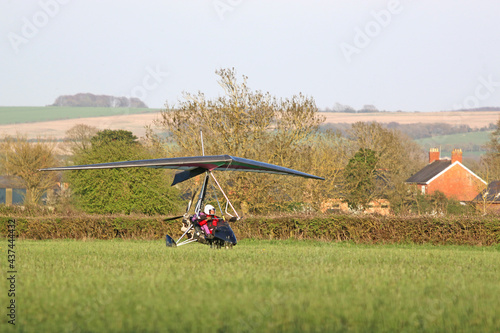 Canvas-taulu Ultralight airplane taxiing on a grass strip