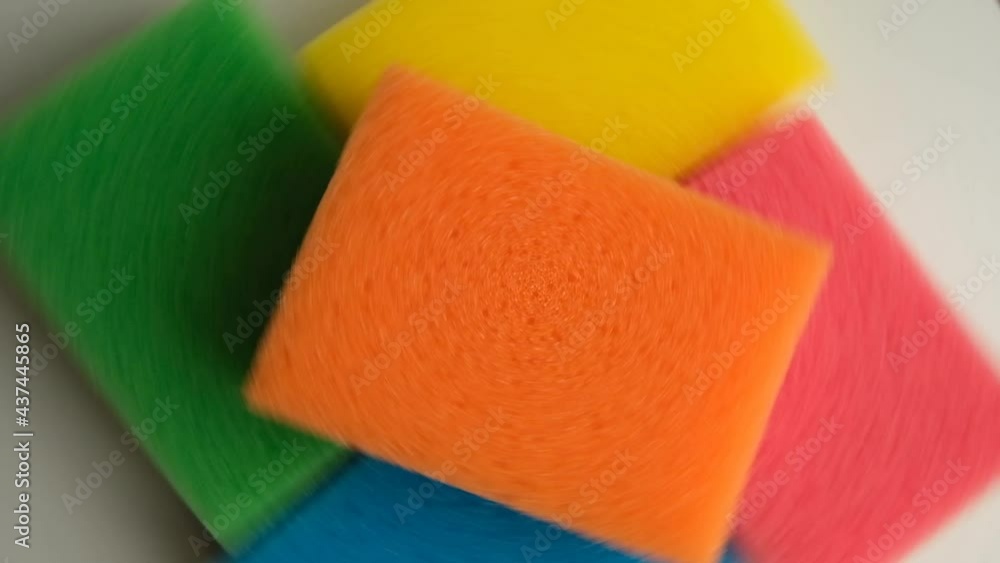 Rotation of sponges for washing yellow, blue, orange, red, green. Kitchen utensils, items for cleaning the premises. Rotation of sponges for washing yellow, blue, orange, red, green. Kitchen utensils, items for cleaning the premises.