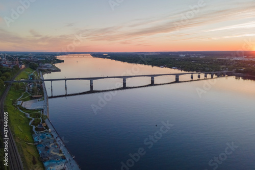 Aerial view of Perm and historical building  Kama river with bridge in sunny summer day with green trees in the sunset