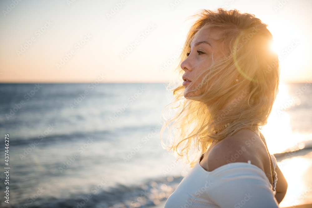 Girl in a white blouse and shorts on the background of the sea Girl in a white blouse and shorts on the background of the sea