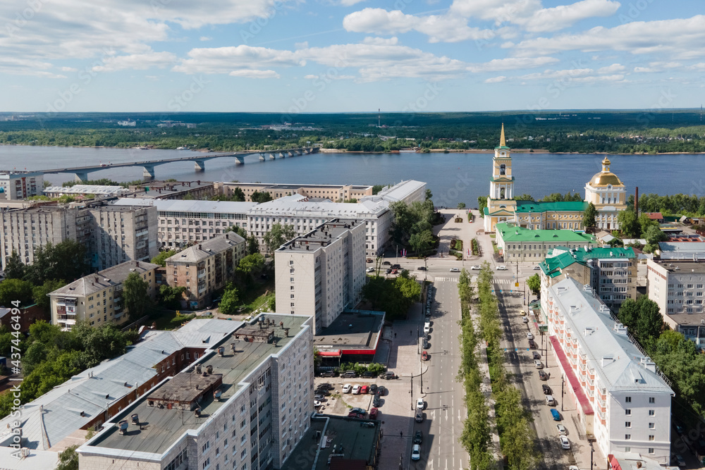 Aerial view of Perm and historical building of art gallery, Kama river with bridge in sunny summer day with green trees