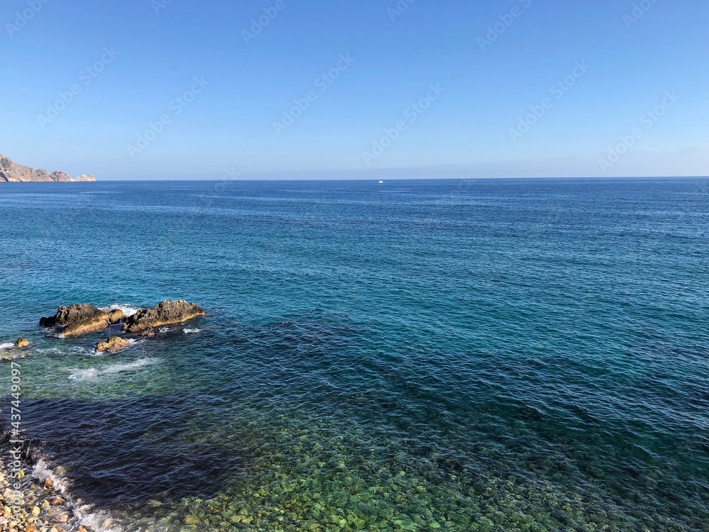 Top view of the beautiful waves of the mediterranean sea breaking on the coast of the rocky coast Top view of the beautiful waves of the mediterranean sea breaking on the coast of the rocky coast