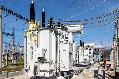 a powerful transformer substation with many connected high-voltage wires and cables, Transformers of various capacities and voltages.