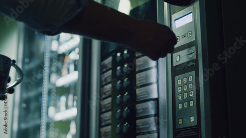 Close up of person choosing food from vending machine photo