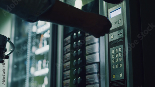 Quadro su tela Close up of person choosing food from vending machine