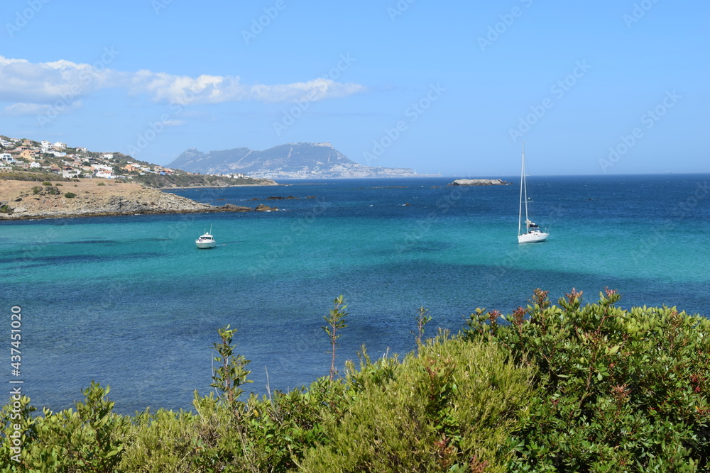 Relaxing on a yacht in the ocean, turquoise water with boats, blue sky and horizon with sailboats, nautical vacations in europe, luxury leisure lifestyle, outdoor water tourism with catamarans