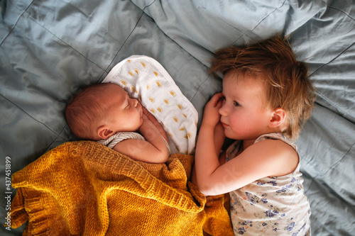Photography cute baby siblings sleep together, newborn baby and toddler older sister, siblin