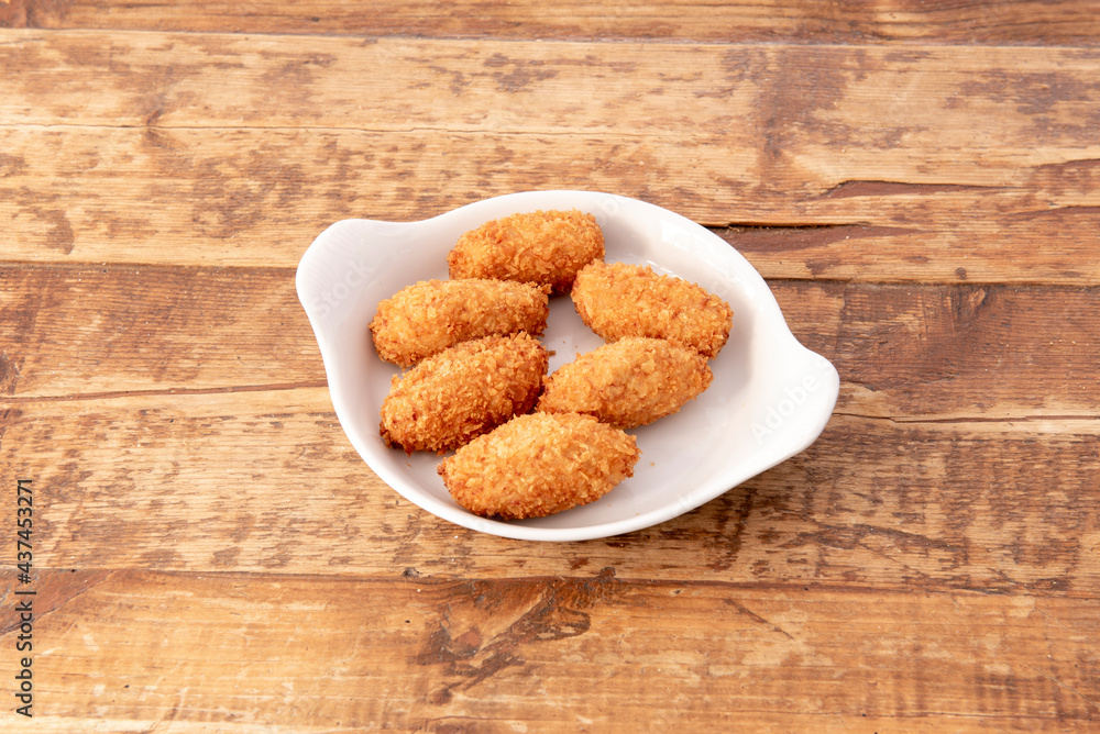 Serving of Iberian ham croquettes served in a Spanish tapas bar Serving of Iberian ham croquettes served in a Spanish tapas bar