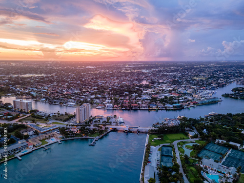 aerial drone of Lighthouse Point Florida with sunset and city