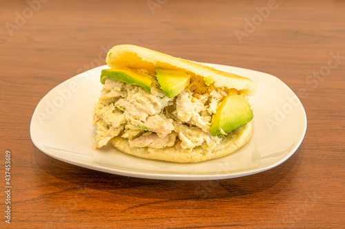 typical Venezuelan arepa recipe queen pepiada with lots of avocado and mayonnaise photo