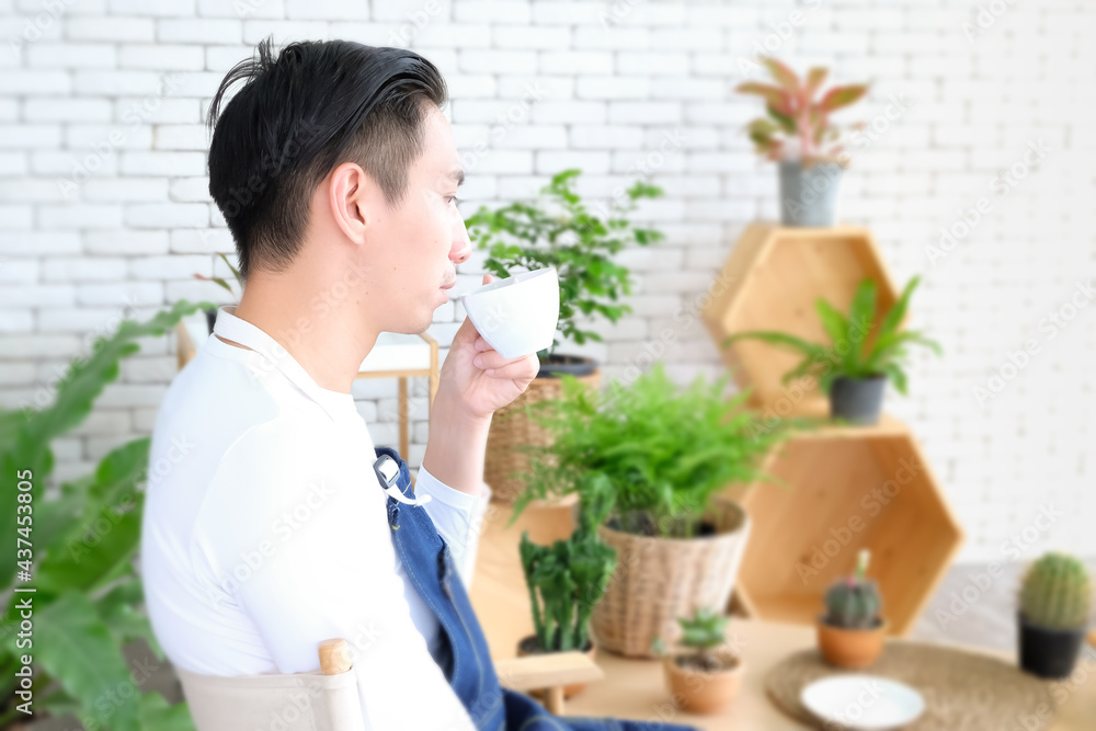 Portraitn Cutie man with coffee, handsome Asian man, Thai-Chinese bastard wearing white shirt. holding cup of tea drinking In morning time In relaxed, Modern businessman at coffee shop or cafe Portraitn Cutie man with coffee, handsome Asian man, Thai-Chinese bastard wearing white shirt. holding cup of tea drinking In morning time In relaxed, Modern businessman at coffee shop or cafe